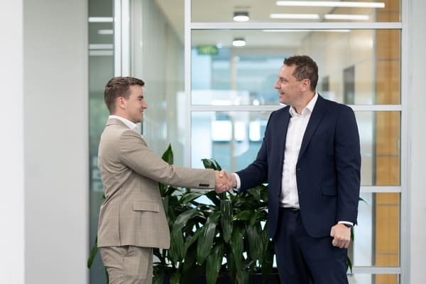 mortgage broker with client shaking hands